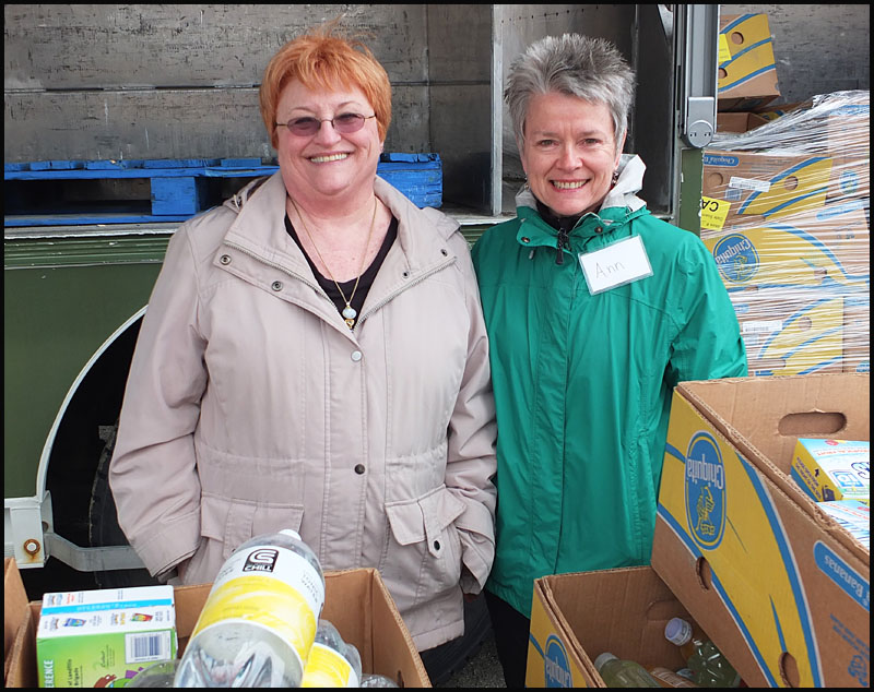 From left, Connie Putman and Ann Walker, just two of the many volunteers who helped distribute free food Tuesday morning.