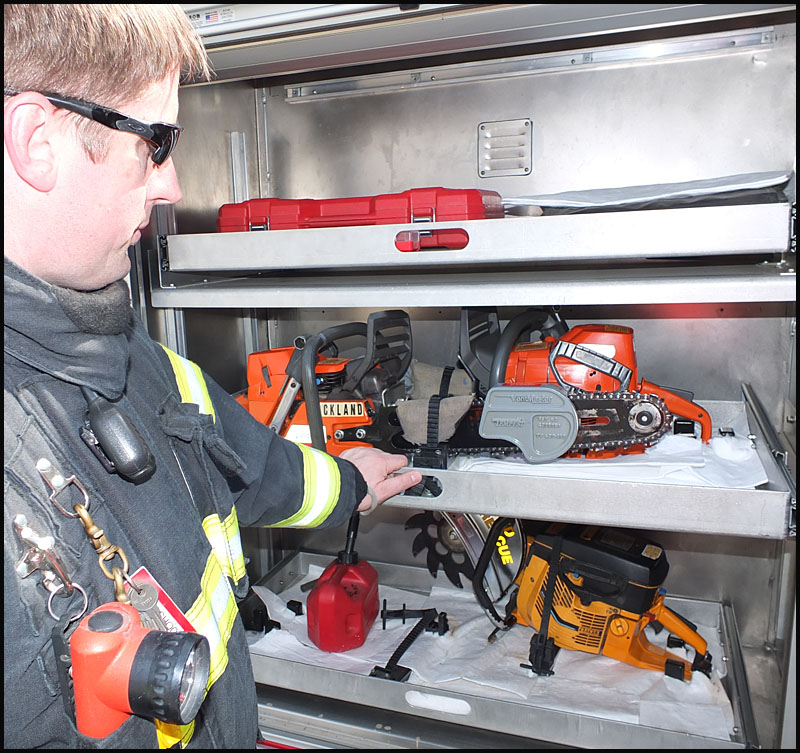 Tom Shook points out various chainsaws for cutting through roofs.