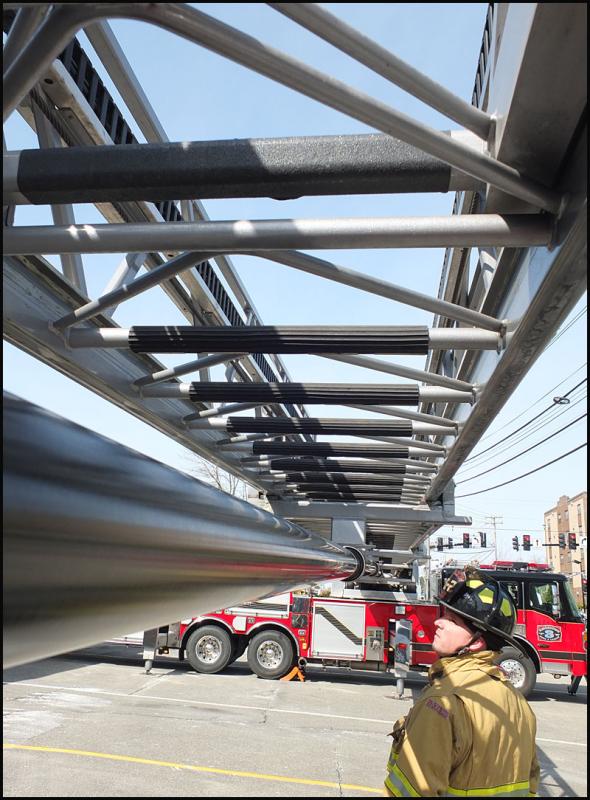 Lowe inspects under the extended ladder