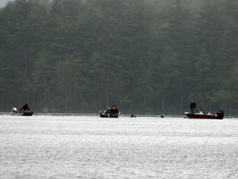 Camden Fire Department rescue swimmers Todd Anderson and Cheyne Hansen join boats searching for this missing sculling boat rower on Megunticook Lake Tuesday morning. (Photo by Holly S. Edwards)