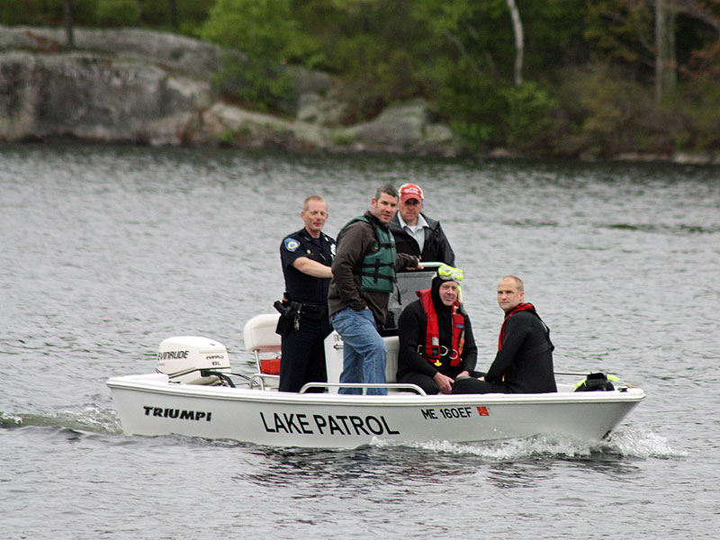 Camden Fire Department rescue swimmers Todd Anderson and Cheyne Hansen are brought back to shore by Lake Patrol Officer Justin Twitchell, along with Camden Police Officer Wes Butler and Camden Fire Asst. Chief Andrew Lowe. (Photo by Holly S. Edwards)