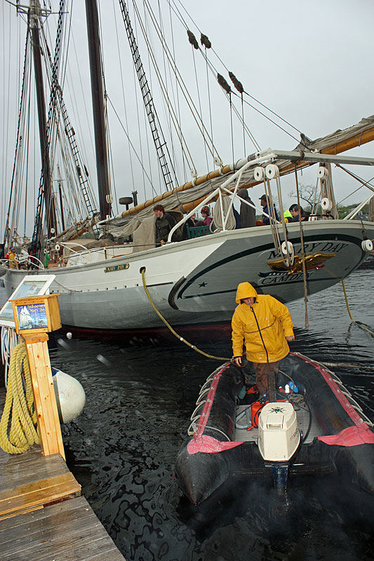 Capt. Jen Martin, wife of Capt. Barry King. mans another small boat to assist in moving schooner Mary Day off its mooring at the head of Camden Harbor. (Photo by Holly S. Edwards)