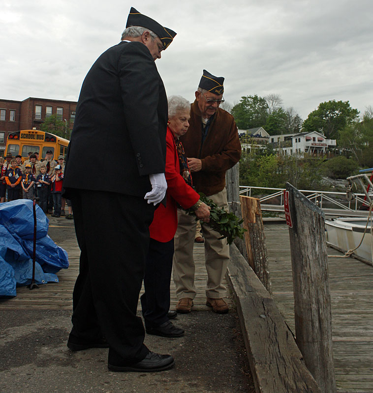 Town historian Barbara Dyer tosses a wreath into Camden Harbor Monday morning during the first of numerous town Memorial Day remembrances. (Photo by Holly S. Edwards)