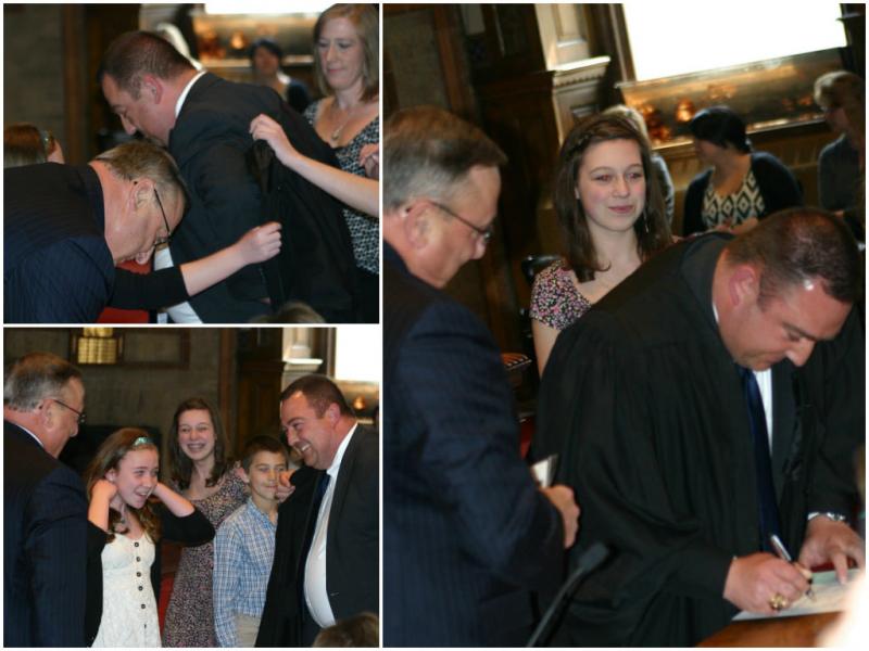 A moment of levity as Walker fumbles with his robe before signing. (photo by Erica Thoms)
