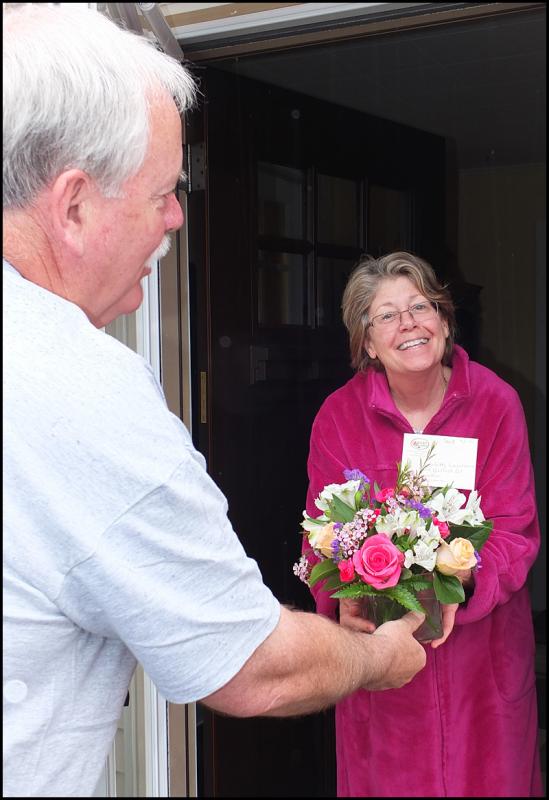 Chief Kelley delivers flowers to Charlotte Lawrence.