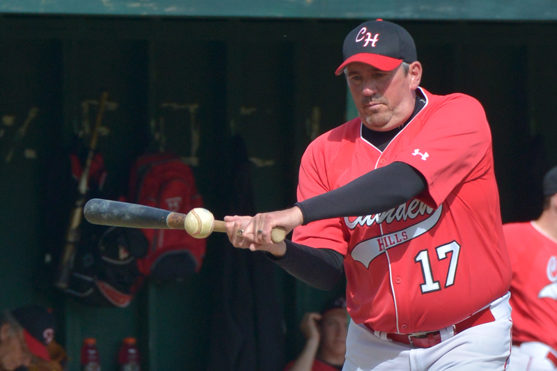 Camden Hills coach Jeff Hart gives his boys some ground balls prior to the start of the game. (Photo by Ron Hawkes)