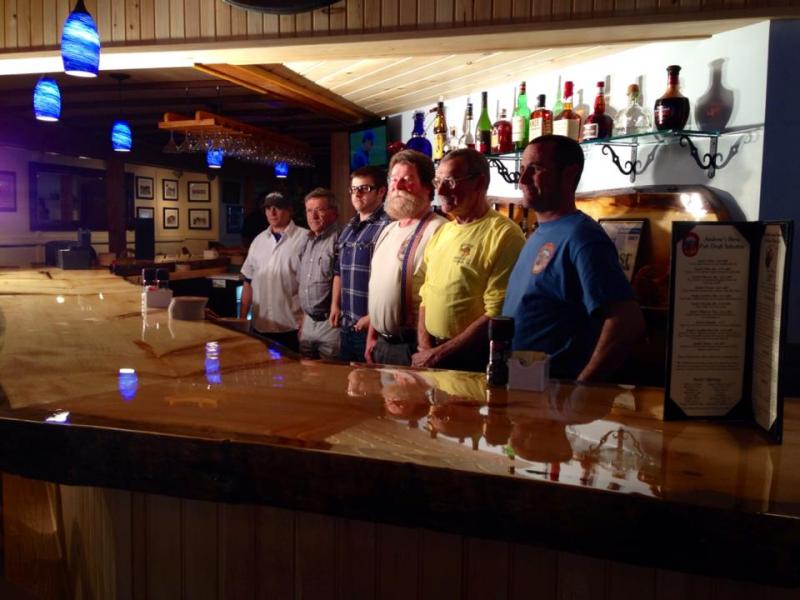 Andy’s Brew Pub owners, investors and staff line up behind the brand new pine bar for their soft opening earlier this month. (Photo courtesy Andy’s Brew Pub)