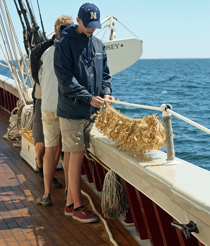 Apprentice Erik Blackwelll works on making the baggywrinkle. (Photo by Holly S. Edwards)