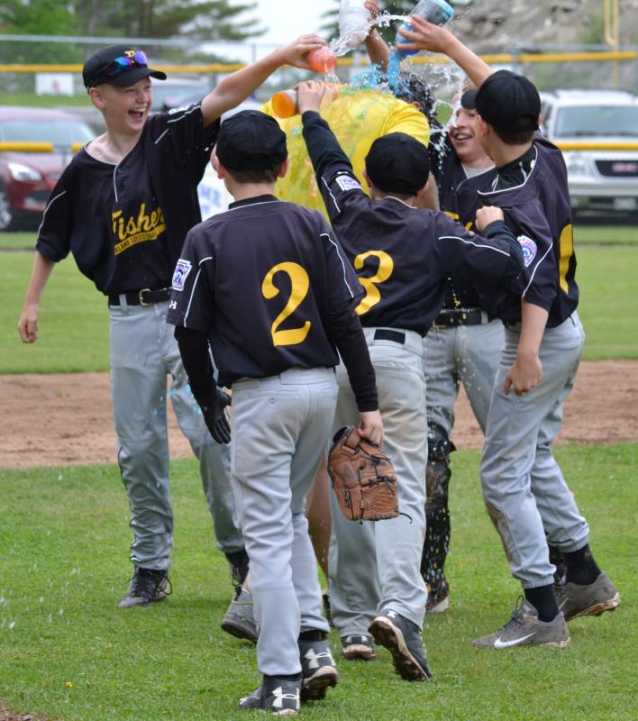 Several Fisher players celebrate their championship victory by dumping Gatorade onto manager John Murphy. (Photo by George Harvey)