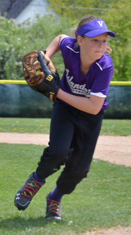An Islanders fielder races to first base in hopes of beating the batter to the bag. (Photo by George Harvey)