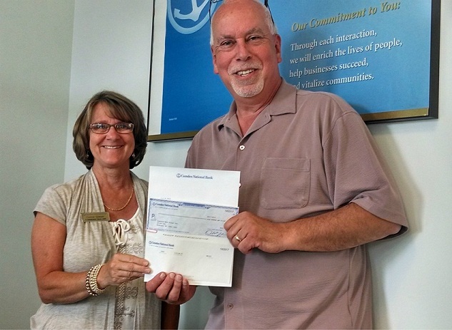 Connie Sawyer, branch manager in Rockland, presents a check to Gordon Page, executive director of Rockland Main Street, Inc.