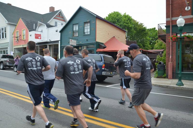 Camden Police Chief Randy Gagne with officers Jeff Boudreau, John Tooley, Tim Davis and Wes Butler head up the hill with Graham Wiley.