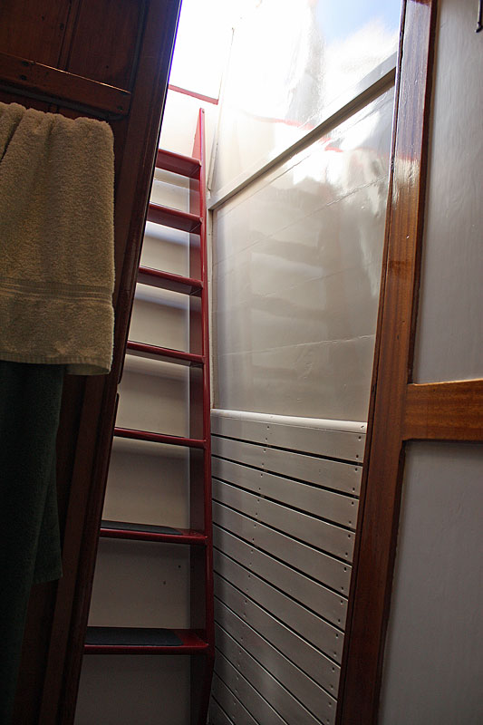 Stairs below deck to the cabins are nearly straight up, so going down backward is the safest way. (Photo by Holly S. Edwards)