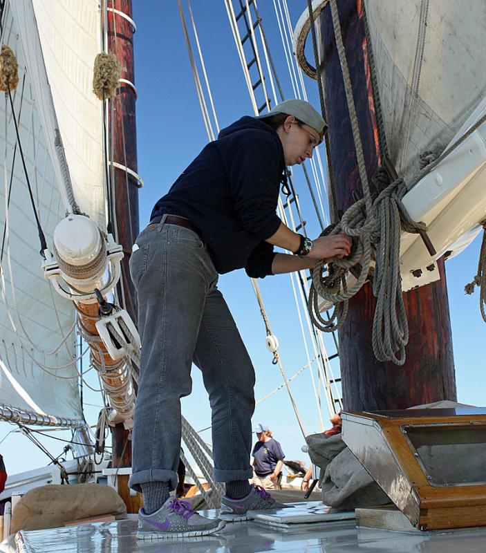 In addition to helping in the galley, Niki Ripple, like all of the crew, helps with lines when the sails go up and down, climbs the mast to lower top masts and helps with raising the anchor. (Photo by Holly S. Edwards)