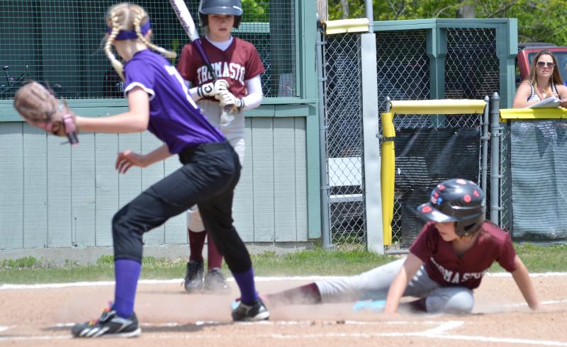 A McMahon Builders player slides into home plate safely. (Photo by George Harvey)