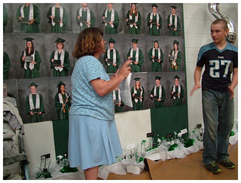 Graduation portraits line the back wall of the Mount View High School gymnasium.