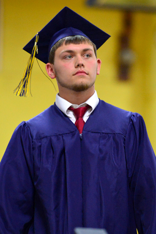 Brandon Leigh Sykes walks off stage with his diploma. (Photo by Ron Hawkes)