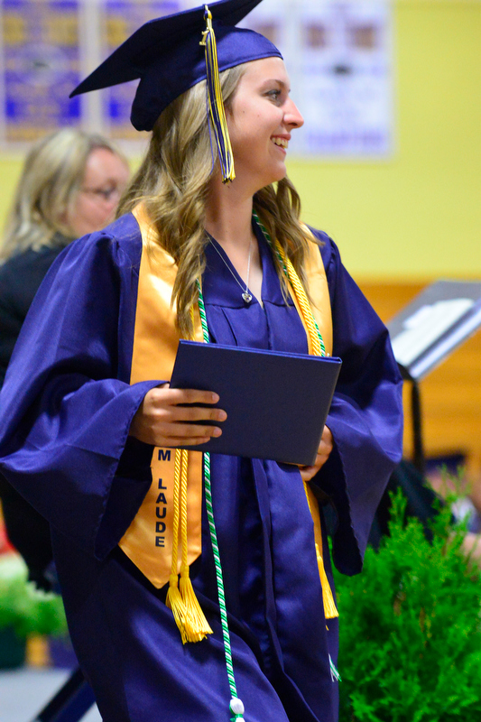 Lauren Nicole Guptill smiles as she holds up her diploma. (Photo by Ron Hawkes)