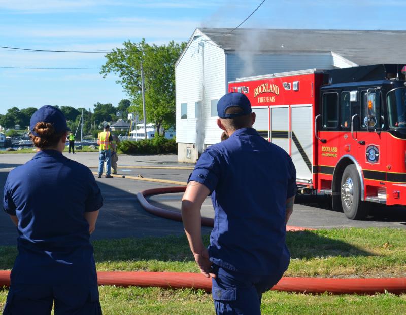 U.S. Coast Guard engineer Kyle Willette (on right), originally from WInslow, reported the fire Sunday morning, June 22. (Photo by Lynda Clancy)