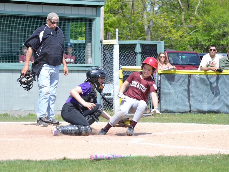 The Islanders catcher tags out a McMahon Builders runner at the plate. (Photo by George Harvey)