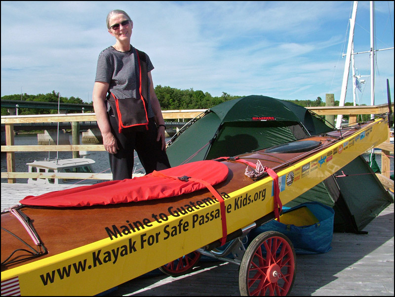 Deborah Walters with the sea kayak she is planning use for a 2,500 mile journey to Guatemala starting next month. The trip is to raise money for Safe Passage, a nonprofit working for families in Guatemala City. (Photo by Ethan Andrews)