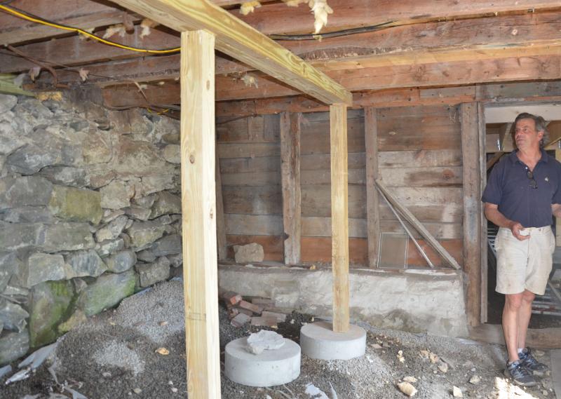 Builder and designer Tom Young, of Rockport, is restoring a simple Greek Revival home in Rockport Village, unearthing layers of history in the edge of a steep hill to the harbor. (Photo by Lynda Clancy)