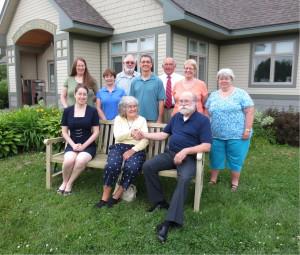 Dorothea Schmitt with Paul Gaudreau and Sue McClintock on the new bench. Standing (from left) are Vose Library board members Heather Bilodeau, Joyce Grotton, Howard Butler, David Poulin, Bruce Cobb, Jan Cramer, and Alison Metcalfe.