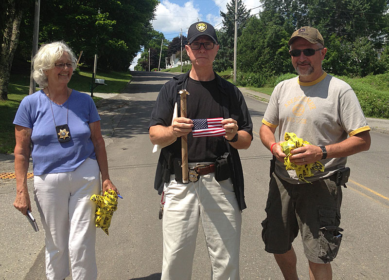 Knox County Sheriff Donna Dennison, Detective Dwight Burtis and Lt. Reggie Walker are all smiles after learning that the suspected incendiary device was just an American flag inside a paper towel tube. (Photo by Lynda Clancy)