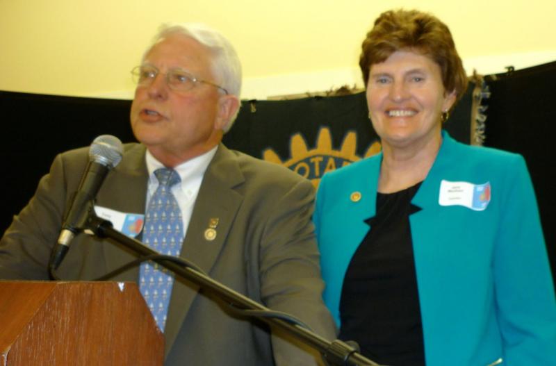 Tony Bates of Rockport hands over the presidency of Camden Rotary Club to Jane Monhart of Union during the club’s annual meeting.