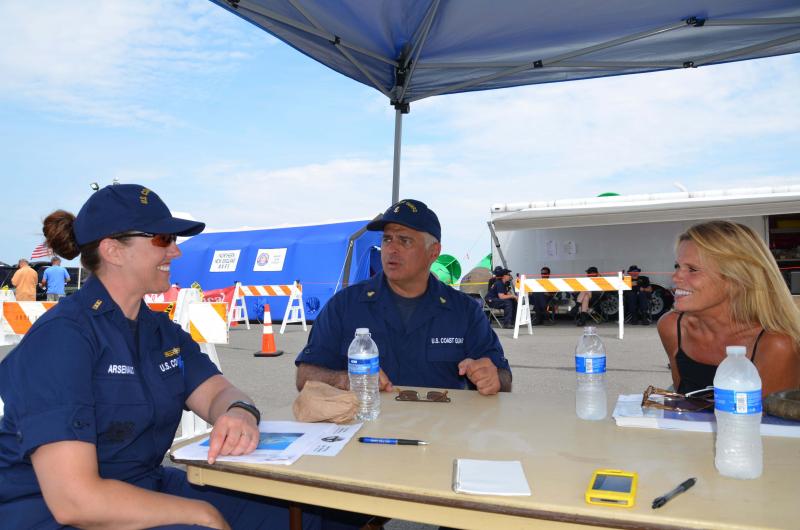 Coast Guard Chief Warrant Officer Kristina Arsenault, Maritime Enforcement Chief Michael Lafond and Julianne Waesche shoot the breeze on the Coast Guard pier in Rockland Harbor Aug. 3. (Photo by Lynda Clancy)