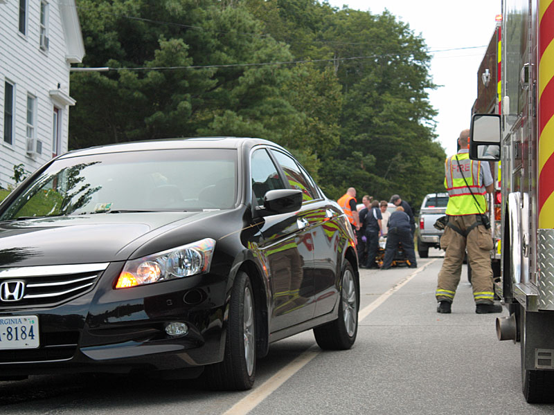 Emergency medical technicians and paramedics tend to 7-year-old Mia Davis on Camden late Tuesday afternoon, after she collided with a passing car while attempting to cross Turnpike Drive (Route 52) in Camden. (Photo by Holly S. Edwards)