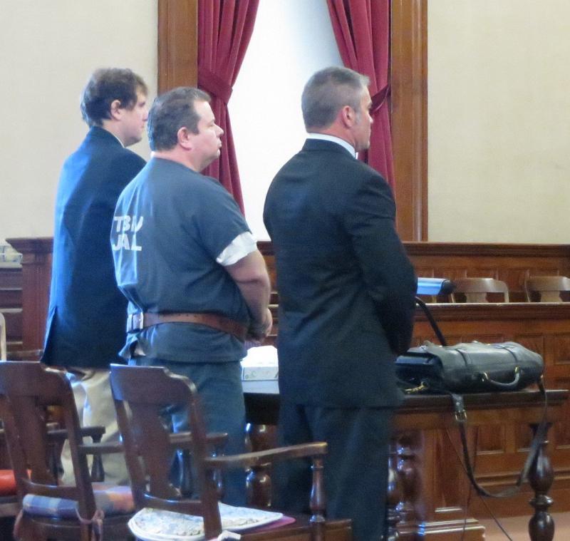 Todd Gilday stands with his public defenders to hear his sentence. (photo by Erica Thoms)