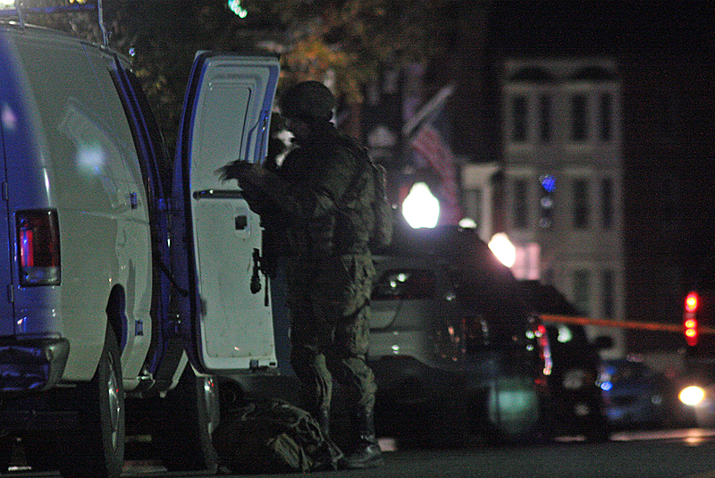 A tactical team member gets more equipment during the Camden Rite Aid Pharmacy standoff. (Photo by Holly S. Edwards)