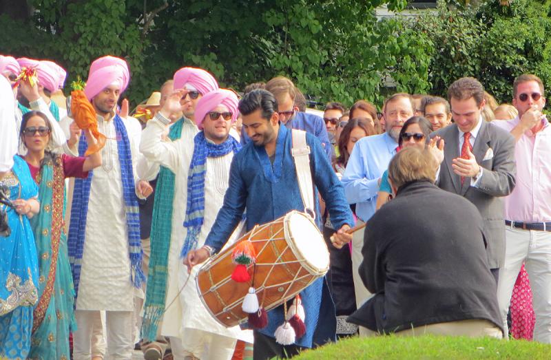 A drummer leads the processional of the groom and his family and friends to the wedding venue in Rockport Village Saturday. (Photo by Richard Anderson)