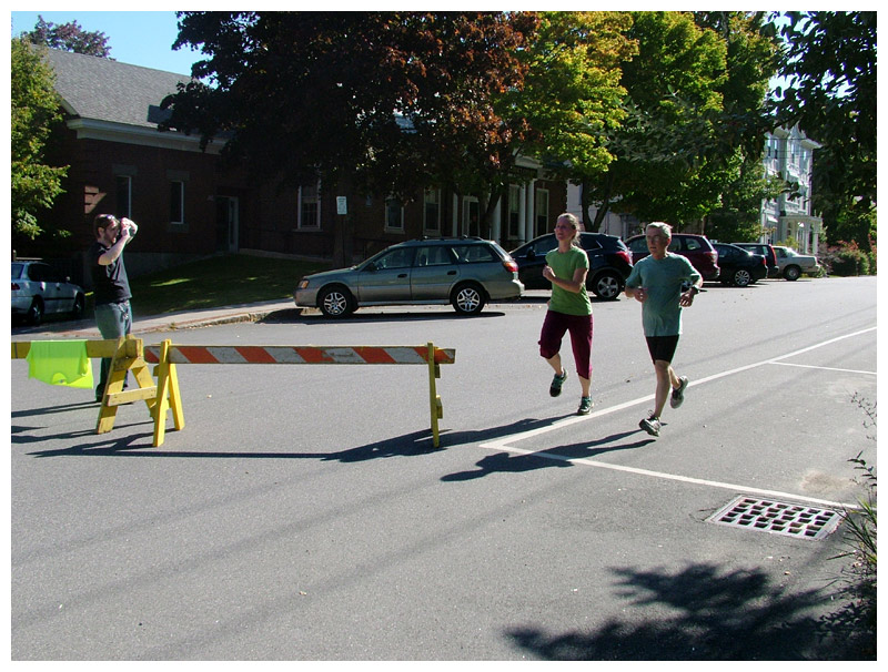 Runners cross the finish line at a 5K sponsored by WeCARE, Sept. 27. (Photo by Ethan Andrews)