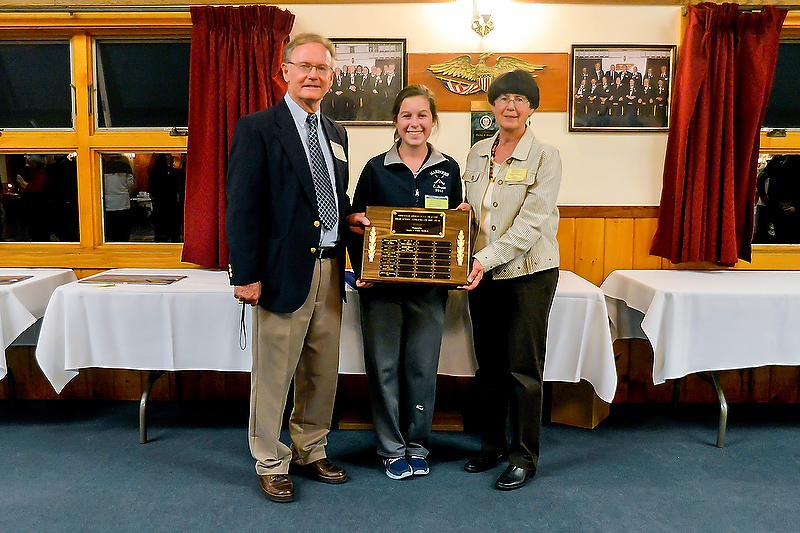 Erin Dugan, middle, stood in for her sister Brooke, who was starting her first college field hockey game Saturday and was unable to attend. Dugan is posing here with the Athlete of the Year sponsors, Charlie and Penny Crockett of C2 Productions. (Photo by Ron Hawkes)
