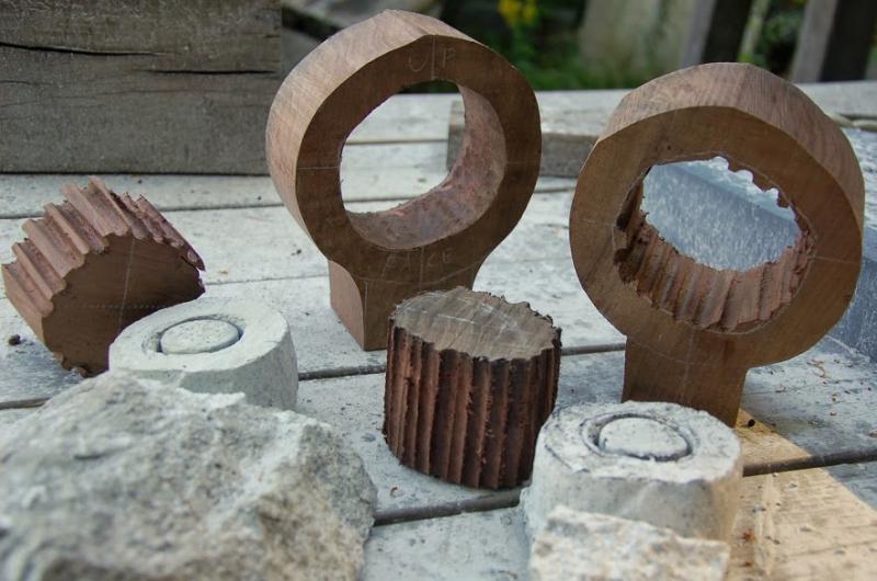 The award’s pieces: a large black walnut ring, a smaller white granite ring on a bronze rod, and a slate base. (Photo courtesy Steve Lindsay)