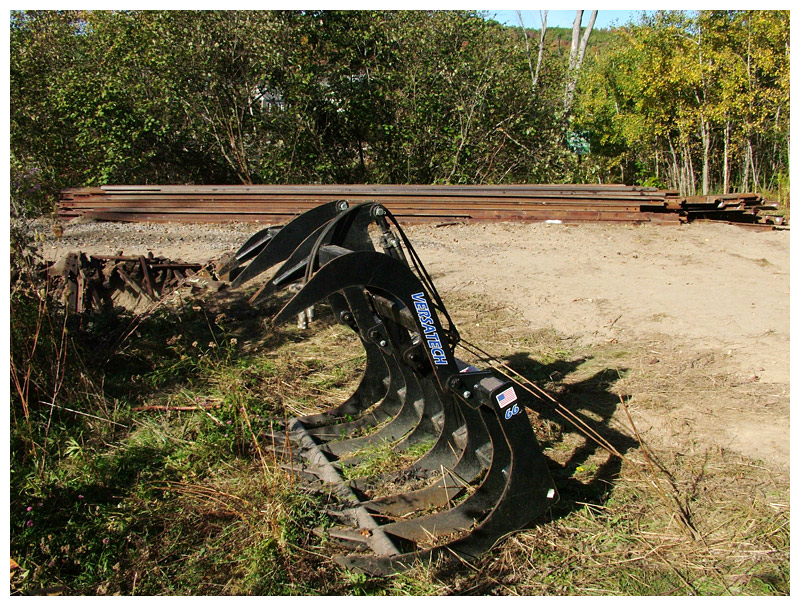 One of several pieces of equipment being used to pull up railroad tracks and ties in Belfast. In the background, a stack of rails. (Photo by Ethan Andrews)