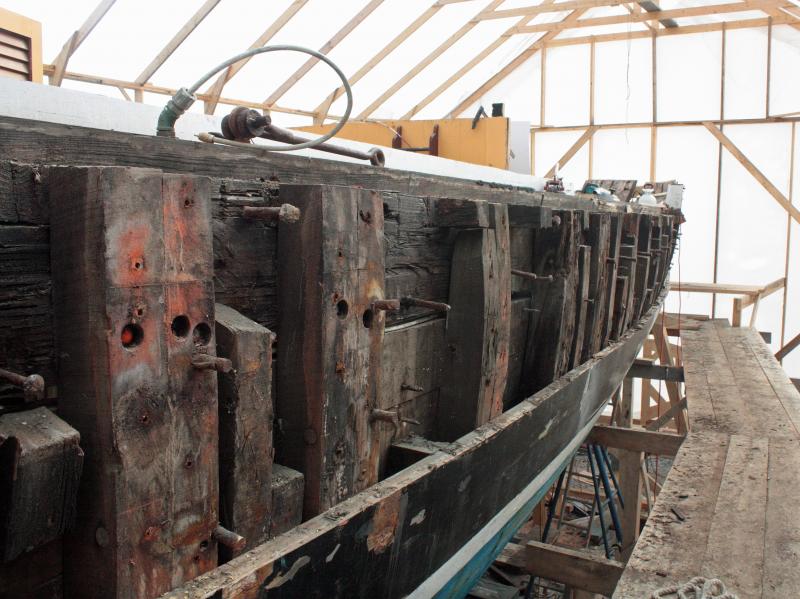 A climb up the scaffolding affords views of the ‘Nathaniel Bowditch’s’ deck and inside the hull, among other open areas that will be rebuilt. (Photo by Holly S. Edwards)