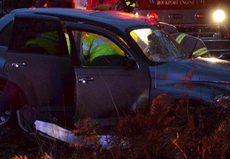 North East Mobile Health EMTs assist the injured driver as firefighters get ready to cut the car apart and pull her out. (Photo by Lynda Clancy)
