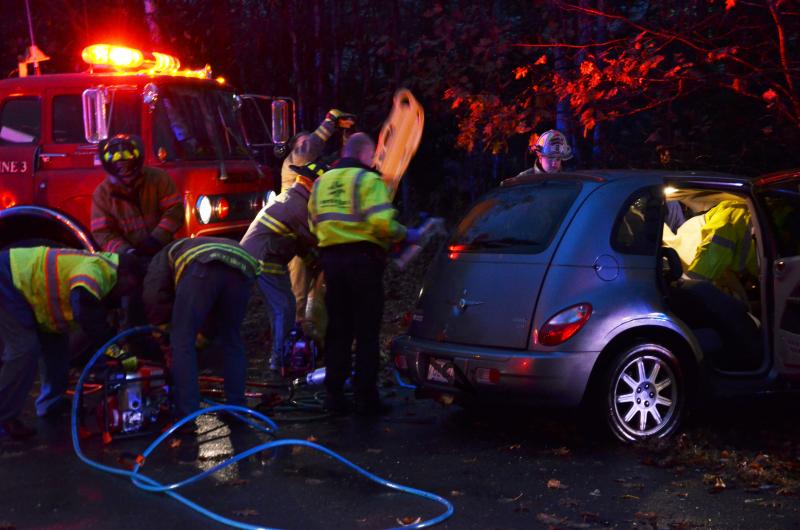 Ambulance, police and firefighters attempt to save a woman trapped in her vehicle. (Photo by Lynda Clancy)