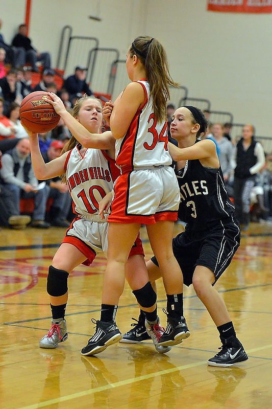 Camden Hills' Laticia Billings, left, tries to move as she gets caught up with teammate Emily Morse and Lincoln Academy’s Julianna Lafrenaye. (Photo by Ron Hawkes)