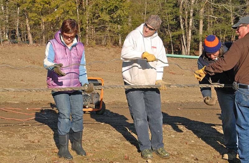 Camden Snow Bowl Asst. Manager Beth Ward and her husband, Wade join in on the splicing work Dec. 27. (Photo by Dave Ridley)