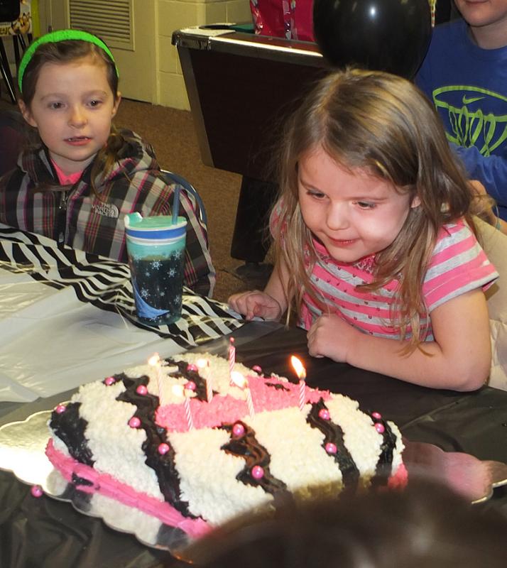 Maddisen Knowlton, of Rockland, turns 6 and blows out the candles at her birthday party at Park Lanes.