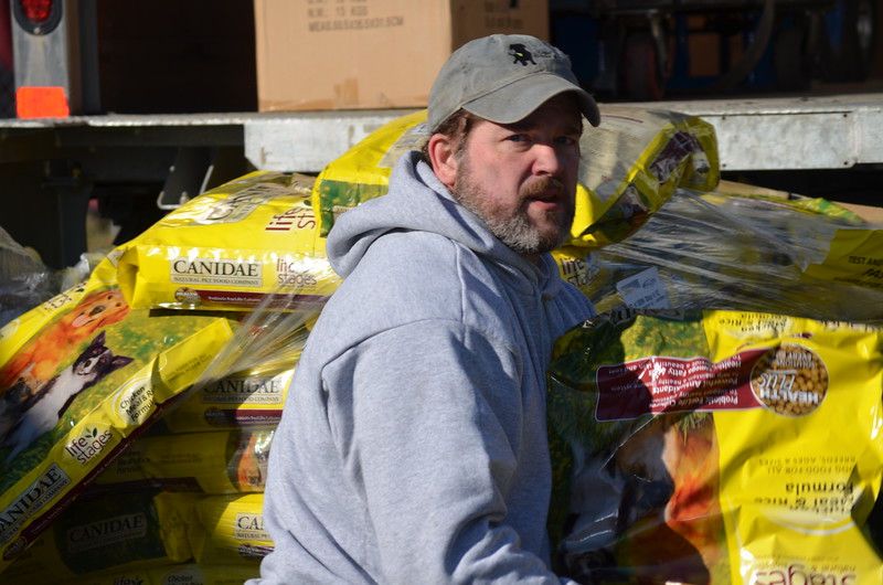 Joel Neal, Heidi’s husband, helps out unloading the food. (Photo courtesy Heidi Neal)