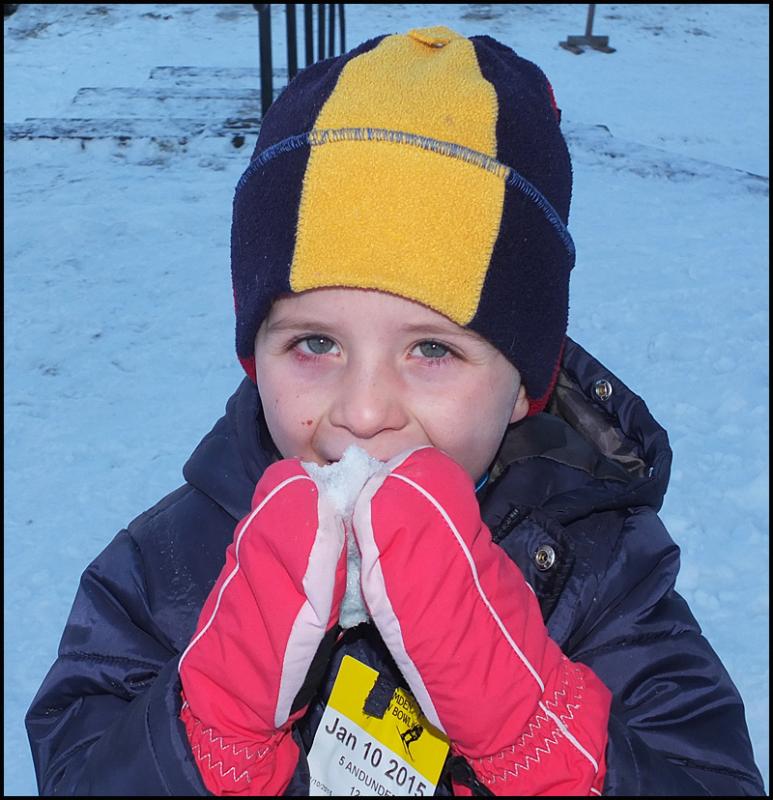 Alden Zimmerman (4) from Hope takes a snow snack break at the Snow Bowl.