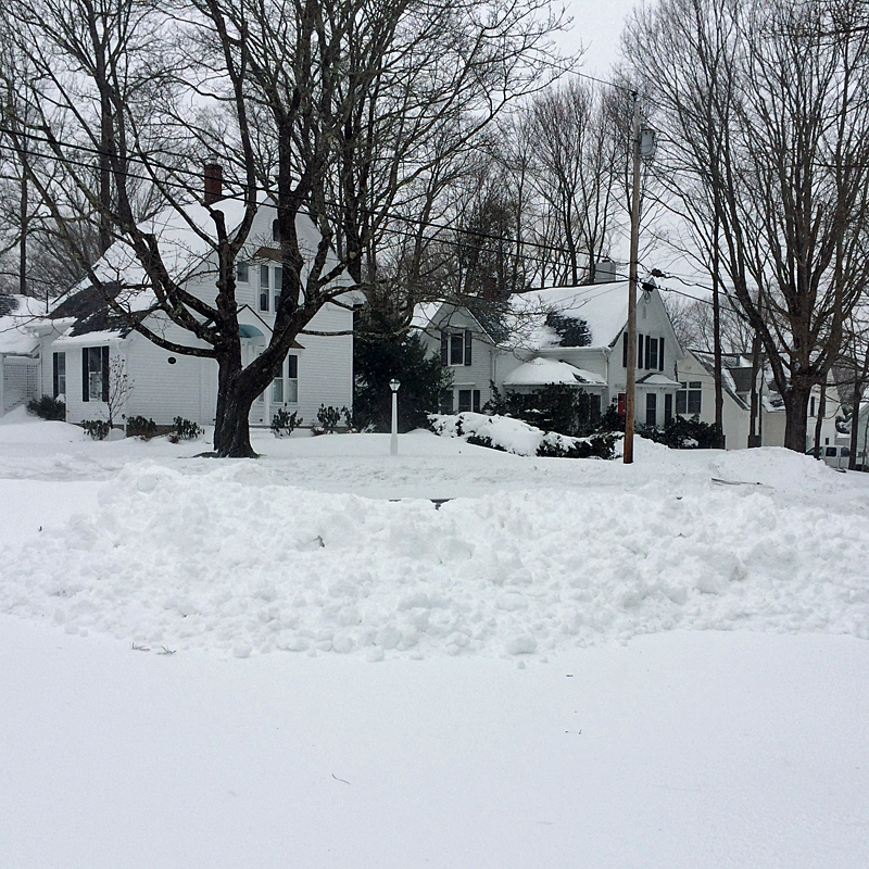 A driveway at 12:30 p.m., and the snow piled up at the end by town snowplows will be bigger come morning. (Photo by Holly S. Edwards)