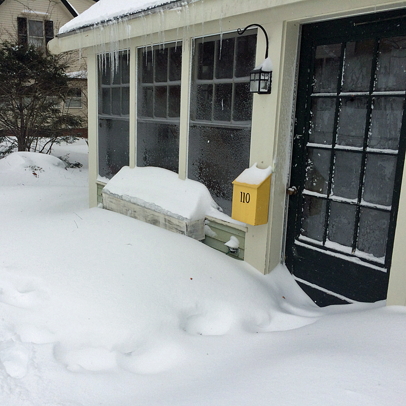 Depending on which direction your entryway faces, Tuesday’s snow can be as deep as this, or blow clear to your neighbor’s yard. (Photo by Holly S. Edwards)