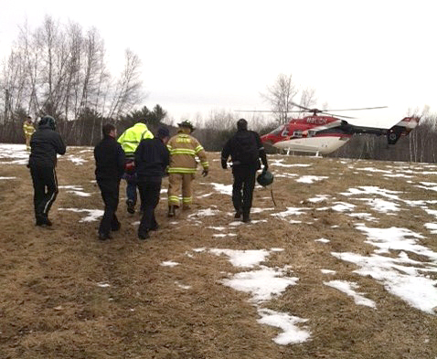 Greene first responders deliver 42-year-old Kenneth Bragdon of Greene Saturday afternoon to a LifeFlight of Maine helicopter, which transported him to Central Maine Medical Center. (Courtesy Maine State Police)