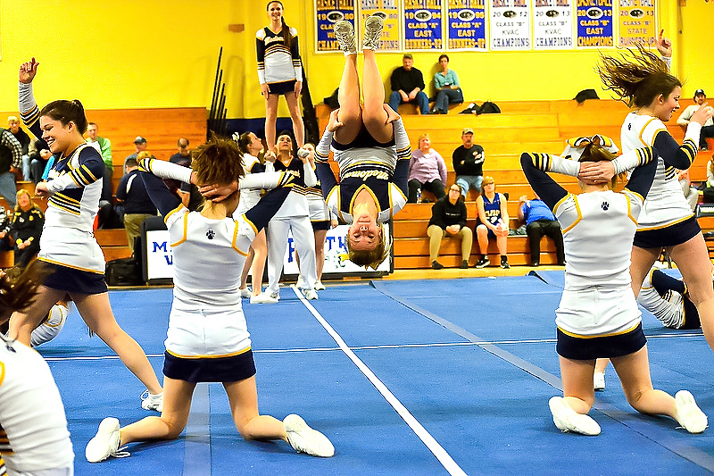 Cassidy Dever, center, flies out with some outstanding tumbling to get the crowd into the routine. (Photo by Ron Hawkes)